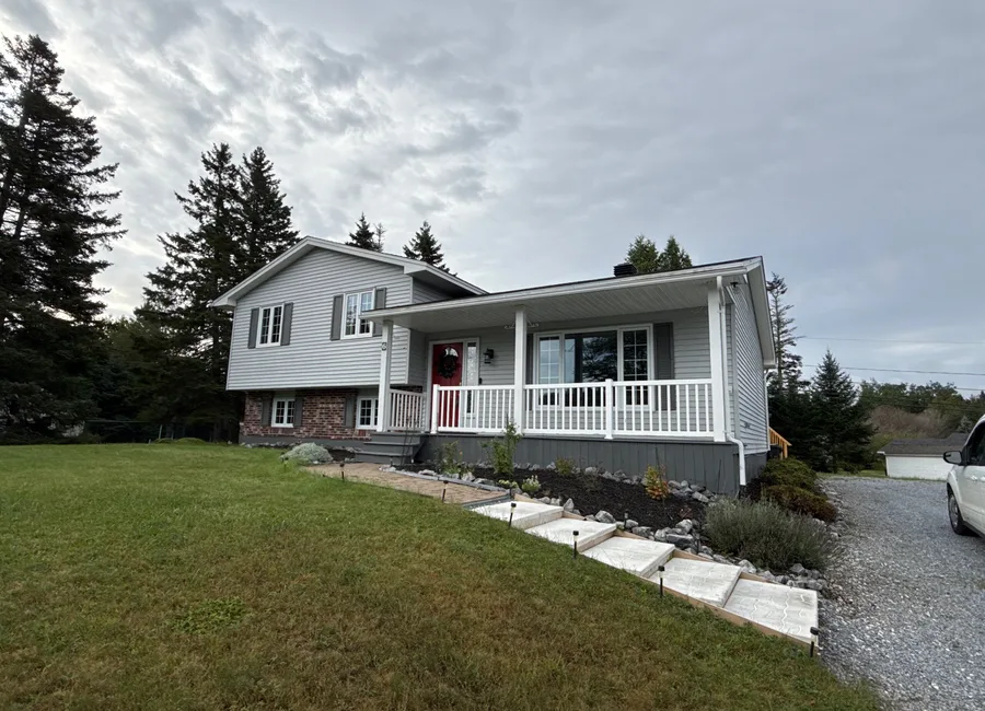 Split level home with a covered front porch and brick lower level in Rothesay, New Brunswick